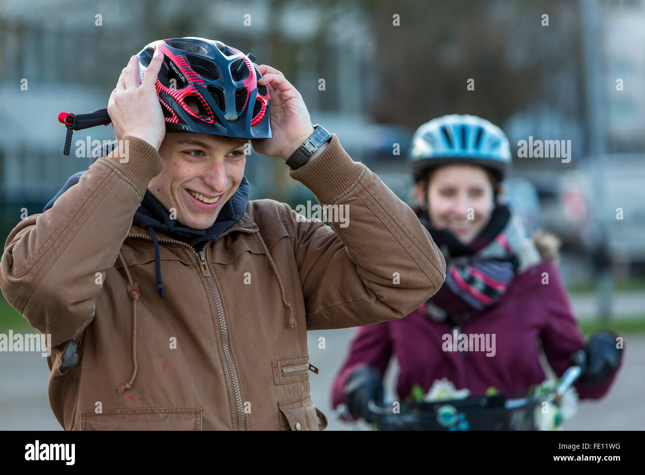 Cyclist put on safety clothing, bike helmet and reflecting vest for