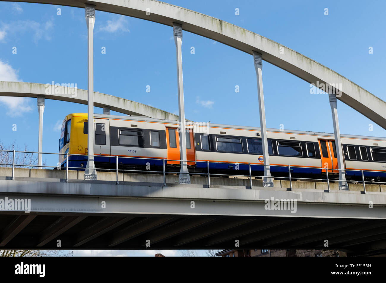 Overground train moving across the railway bridge in Hackney, London England United Kingdom UK Stock Photo