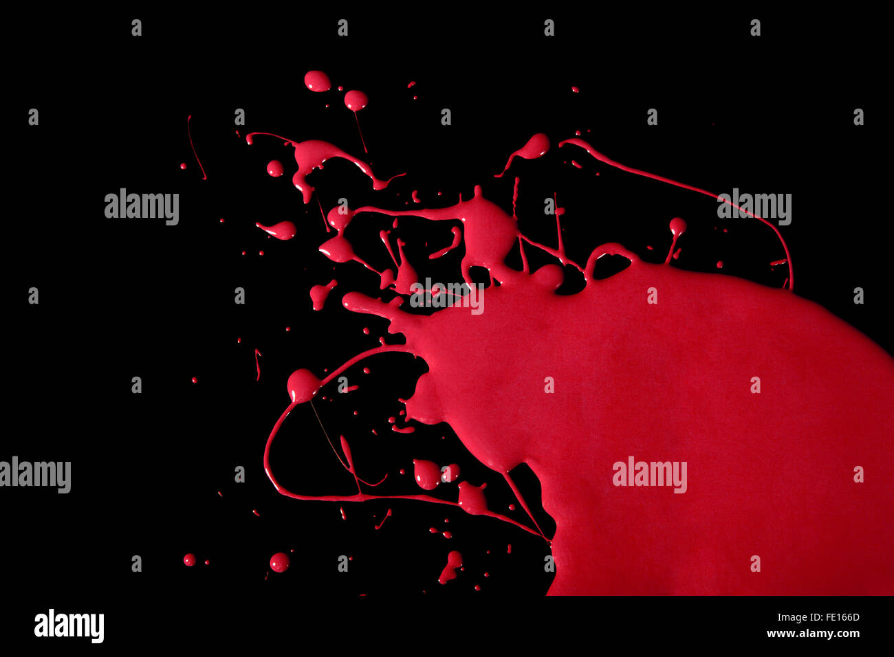 Splattered red paint on a black background Stock Photo