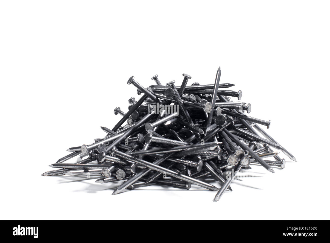 Studio Shot of a Pile of Construction Nails on a White Background Stock Photo