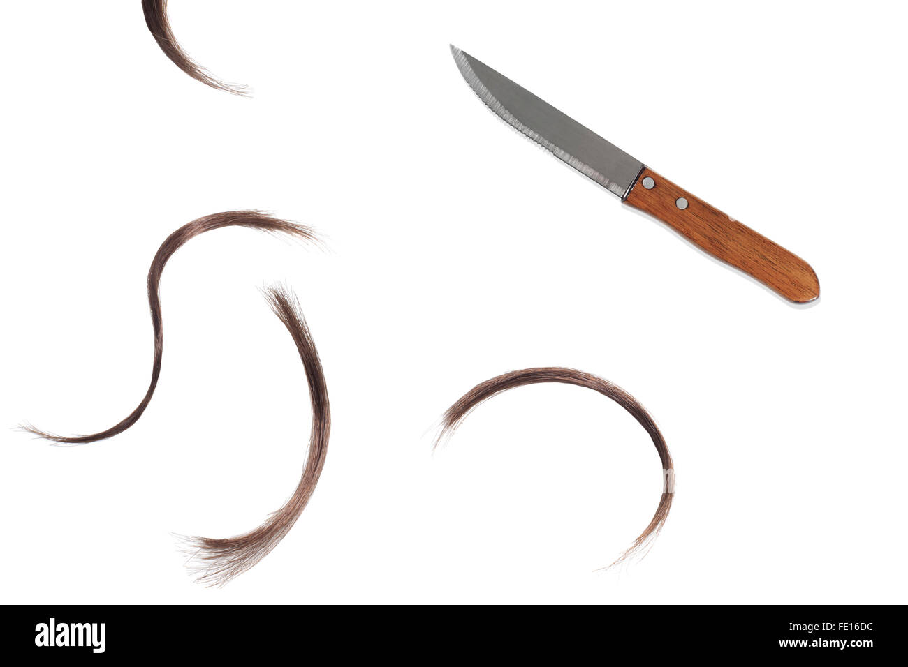 Studio Shot of a Kitchen Knife and Hair Clippings on a White Background Stock Photo