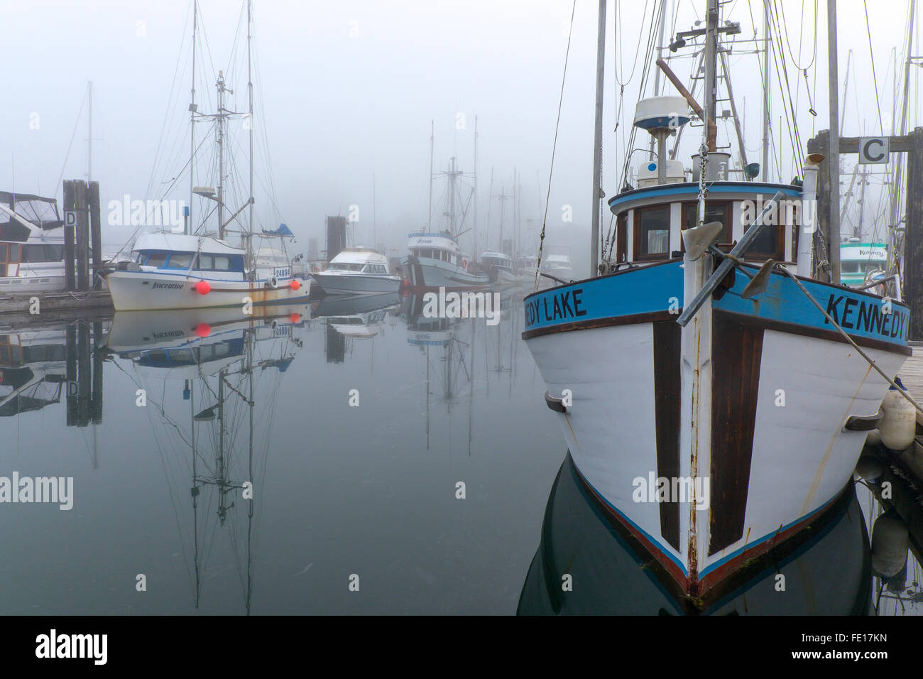 Ucluelet Harbor, British Columbia: Boats in the Small Boat Basin in fog. Vancouver Island, Canada Stock Photo