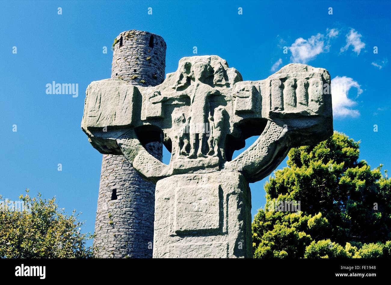 The Unfinished Cross and Round Tower in Celtic Christian churchyard at Kells in County Meath, Ireland Stock Photo