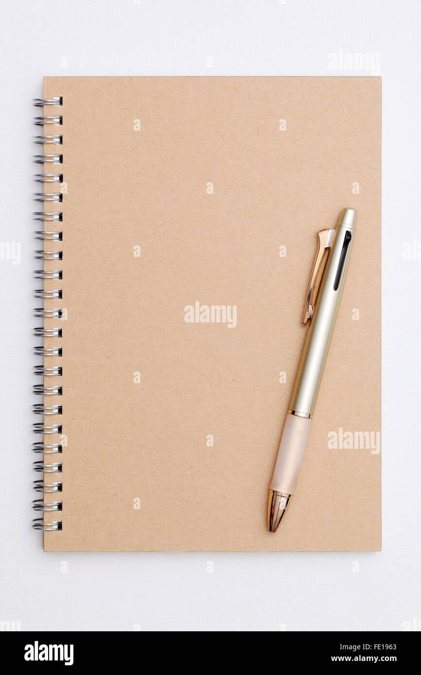 open blank spiral notebook on light brown board Stock Photo by