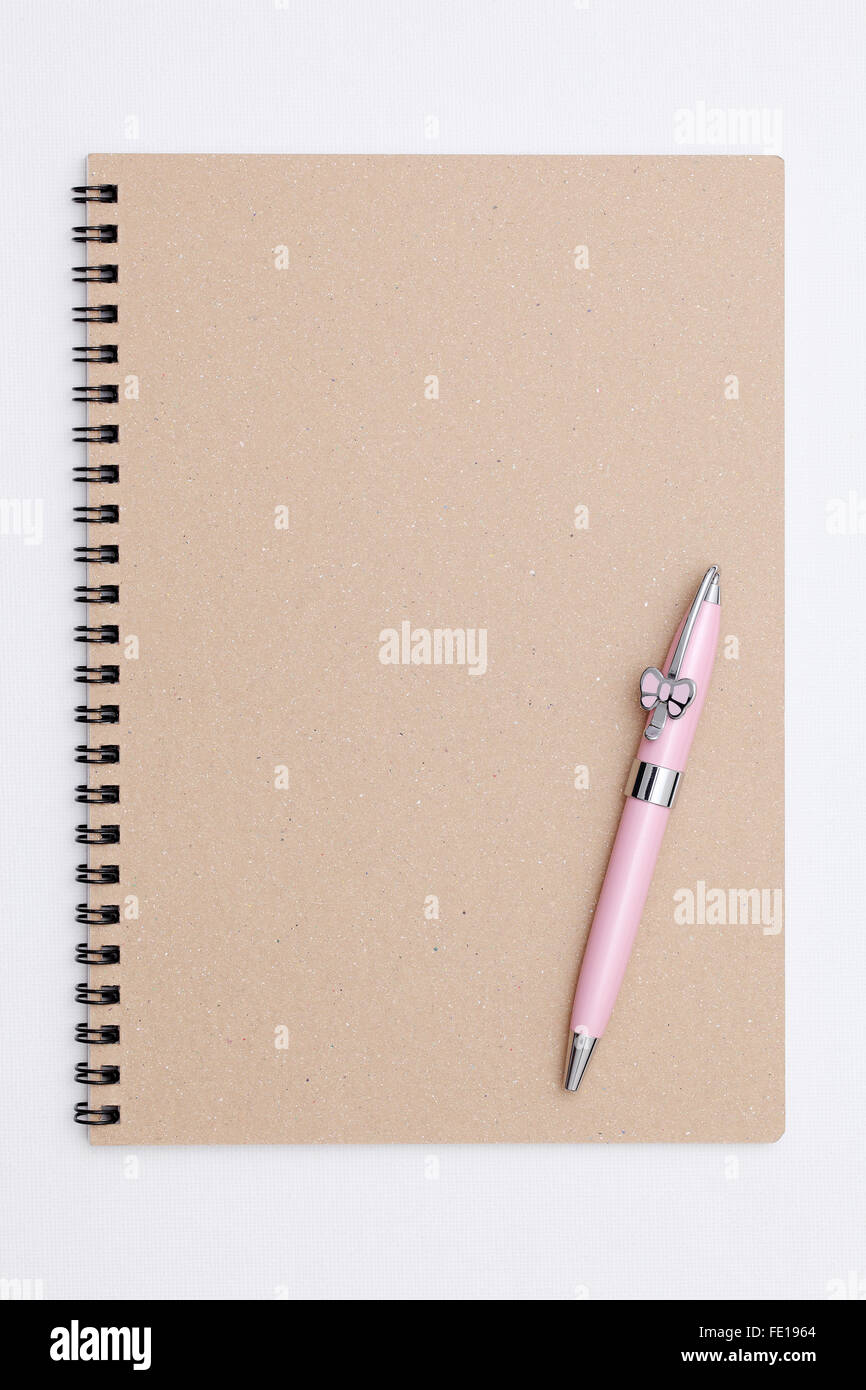 Blank spiral brown notebook with ball point pen Stock Photo