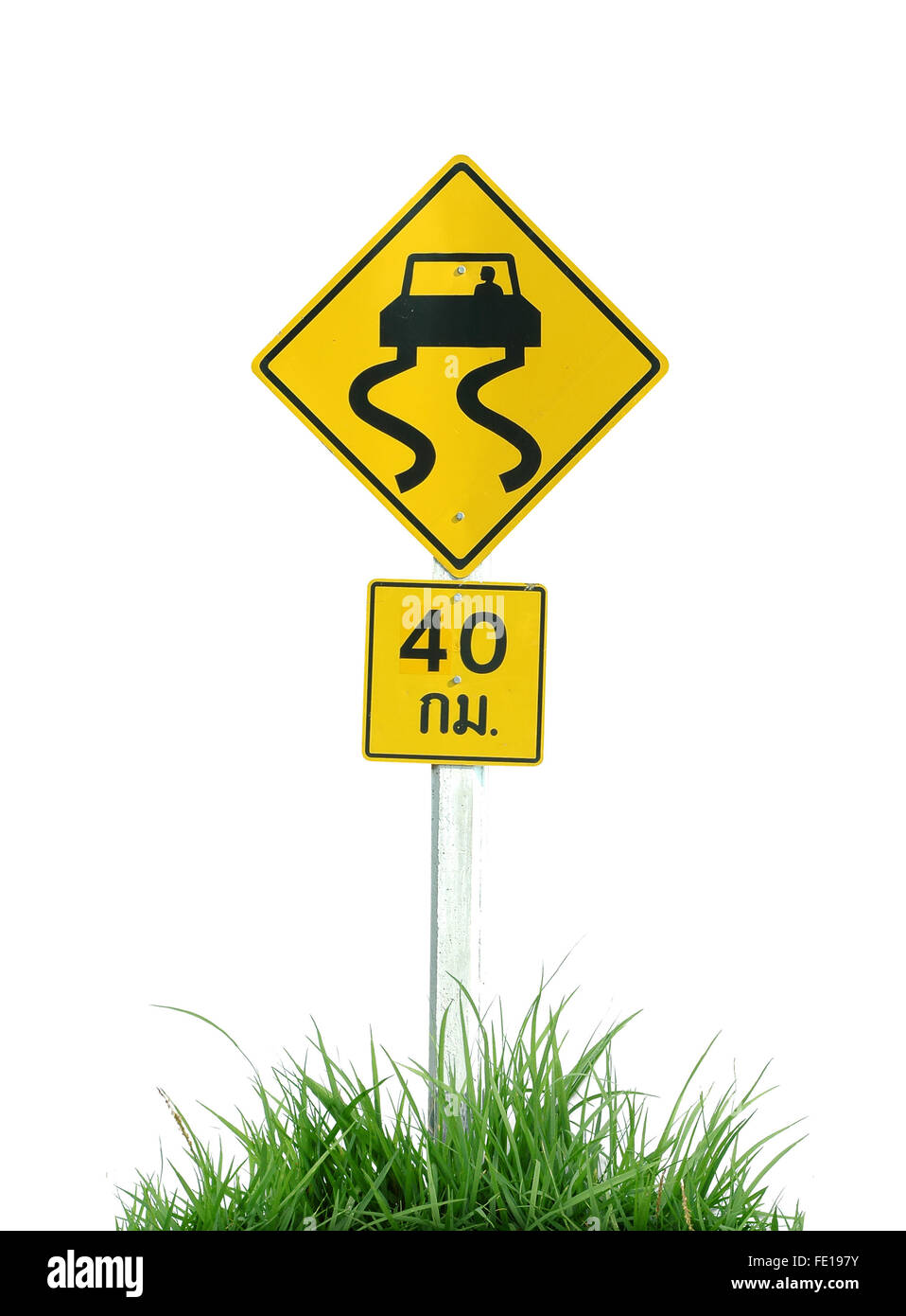 Yellow slippery road sign and green grass isolated on white background Stock Photo
