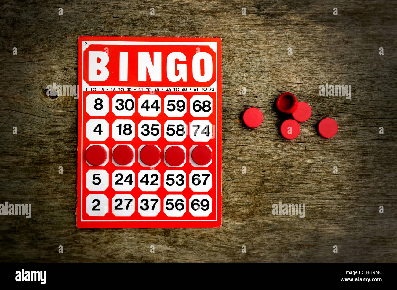 Red bingo card with winning chips Stock Photo Alamy