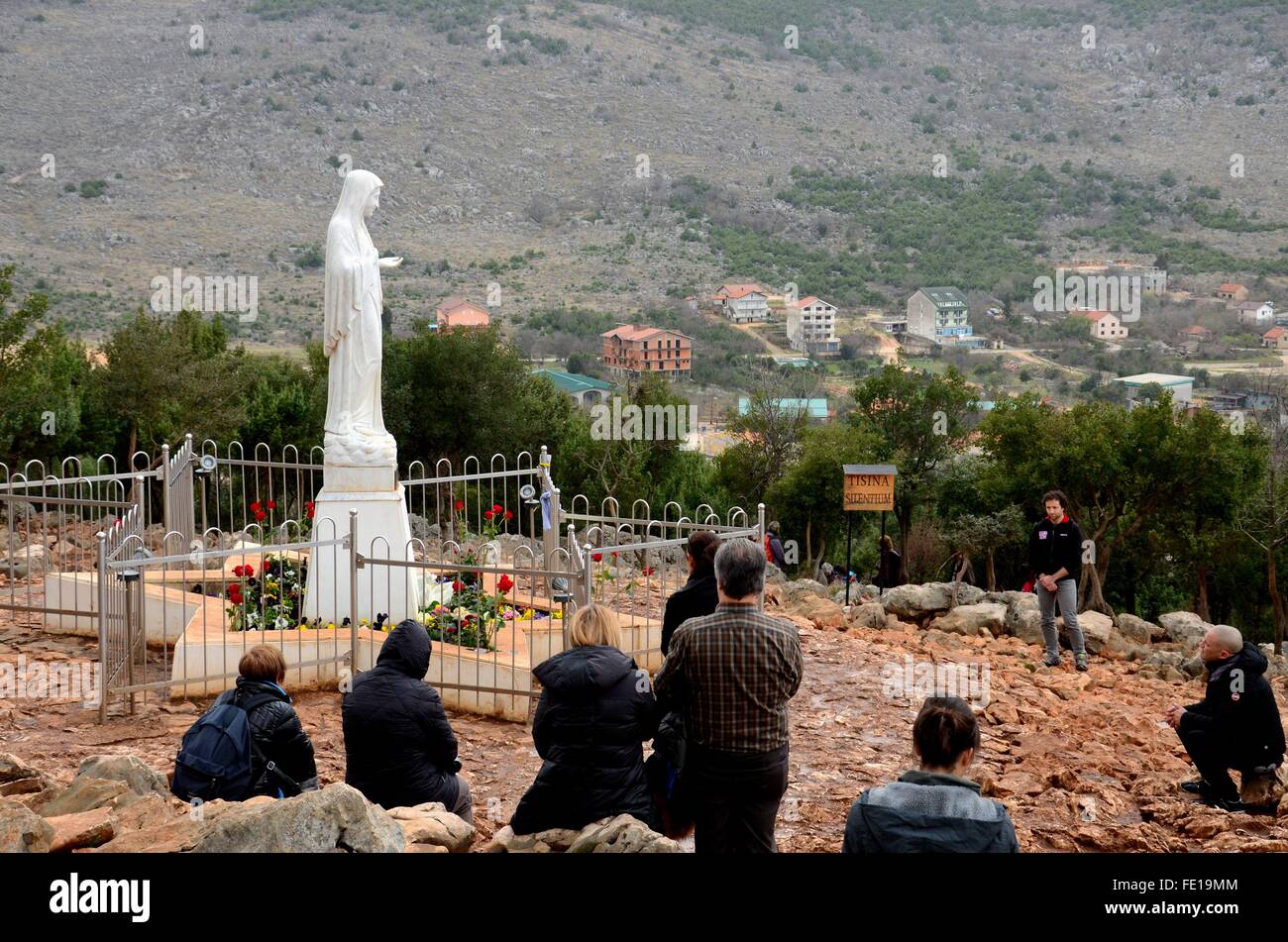 Catholic pilgrim worshipers pray to Virgin Mary statue Medjugorje Bosnia Herzegovina Stock Photo