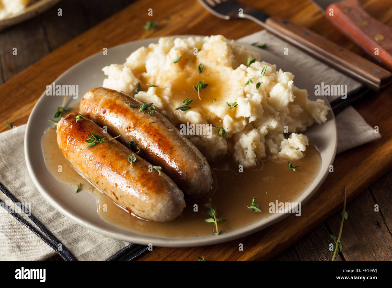 Homemade Bangers and Mash with Herbs and Gravy Stock Photo