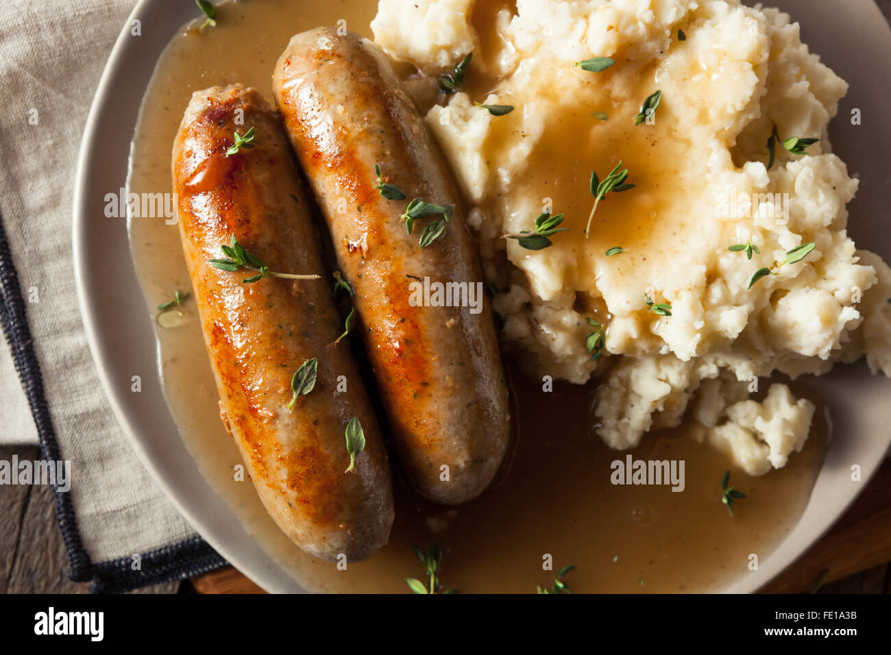 Homemade Bangers and Mash with Herbs and Gravy Stock Photo