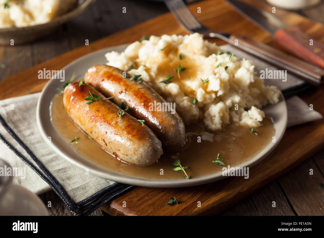 Homemade Bangers and Mash with Herbs and Gravy Stock Photo