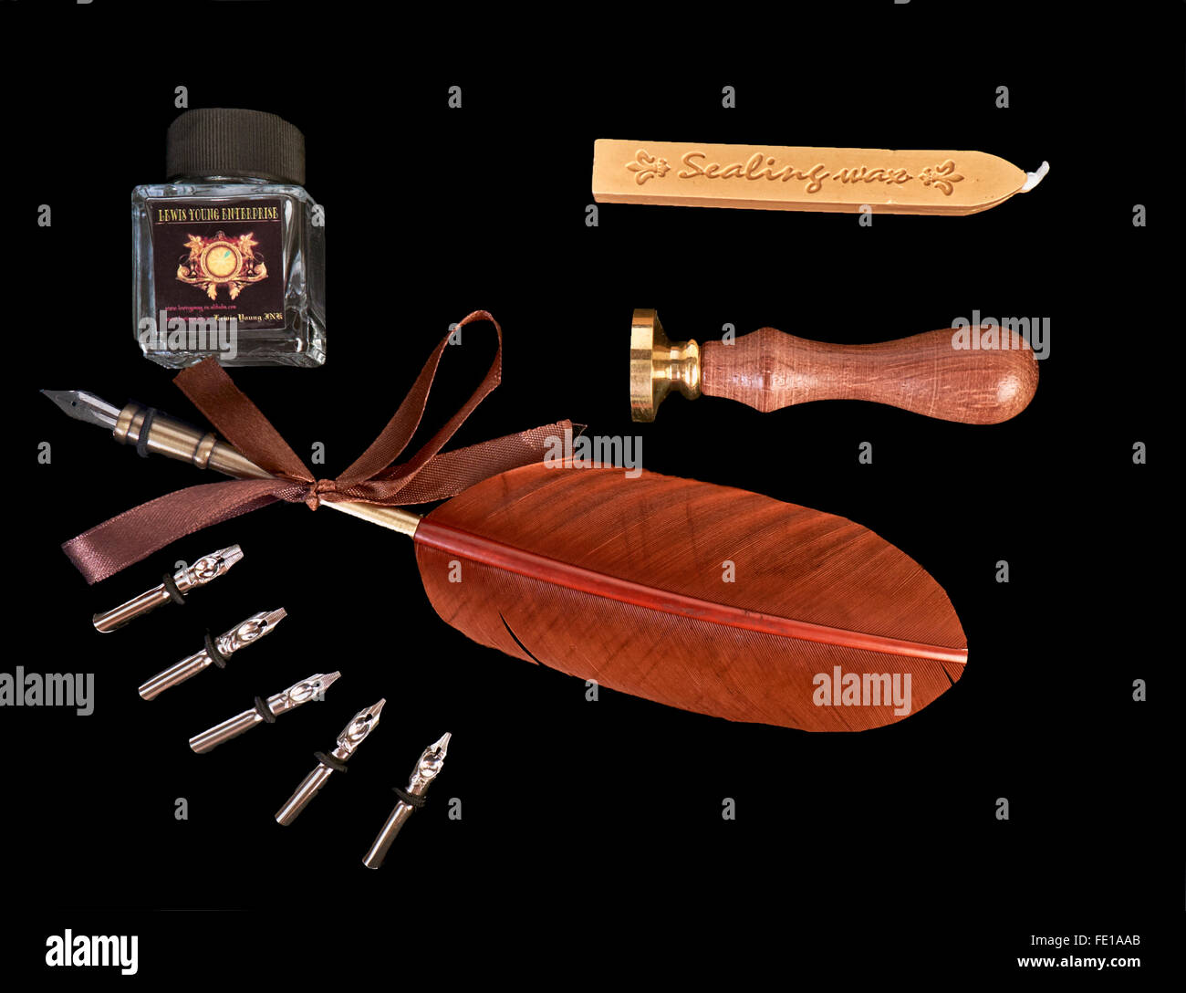 Calligraphy pen writing set against a black background Stock Photo - Alamy