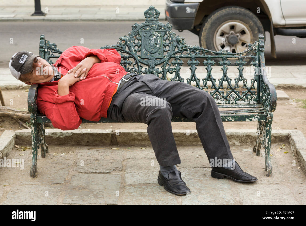 Man sleeping on a park bench in Oaxaca City, Oaxaca, Mexico Stock Photo
