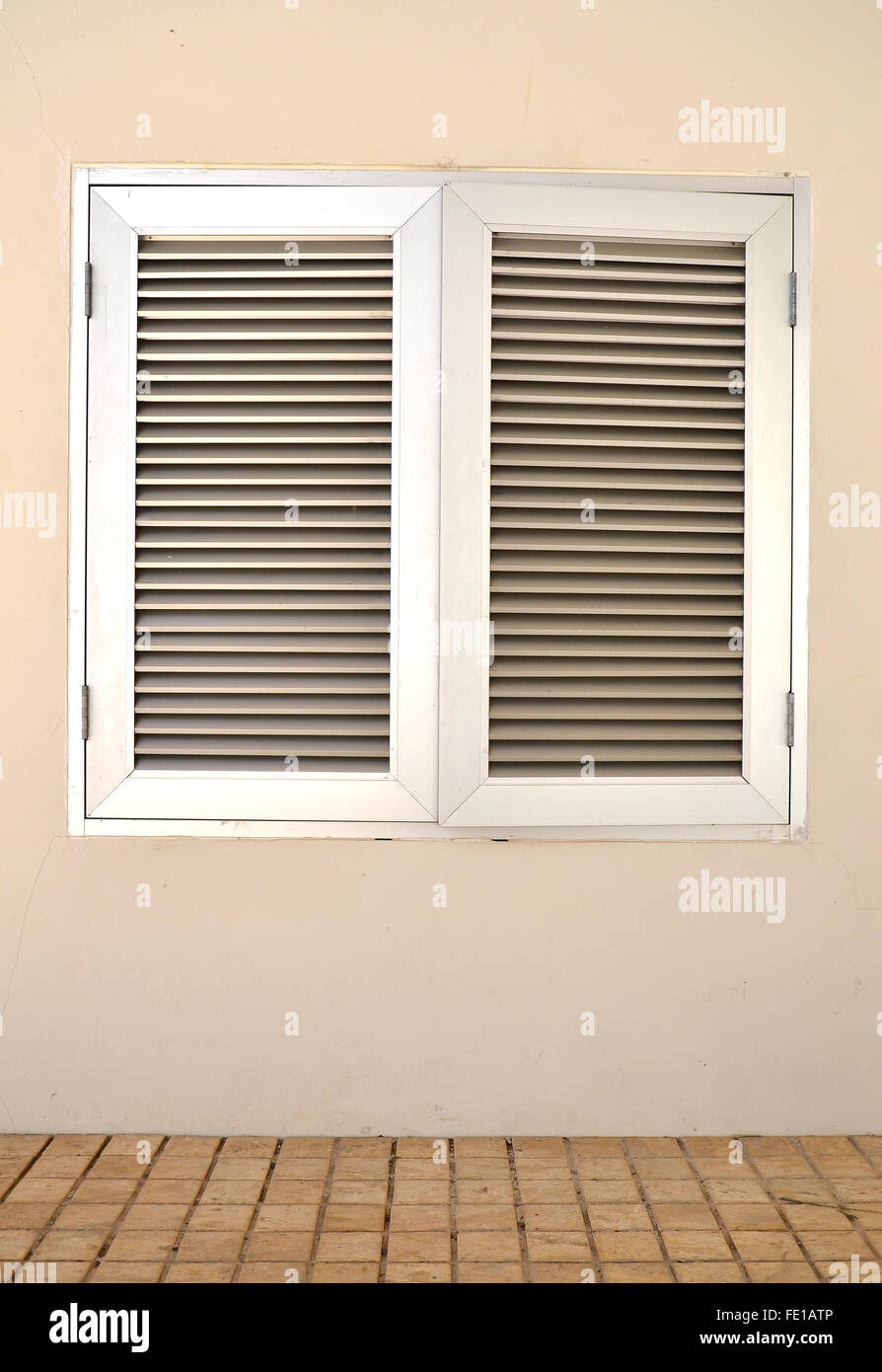 An industrial ventilation fan attached to a building Stock Photo