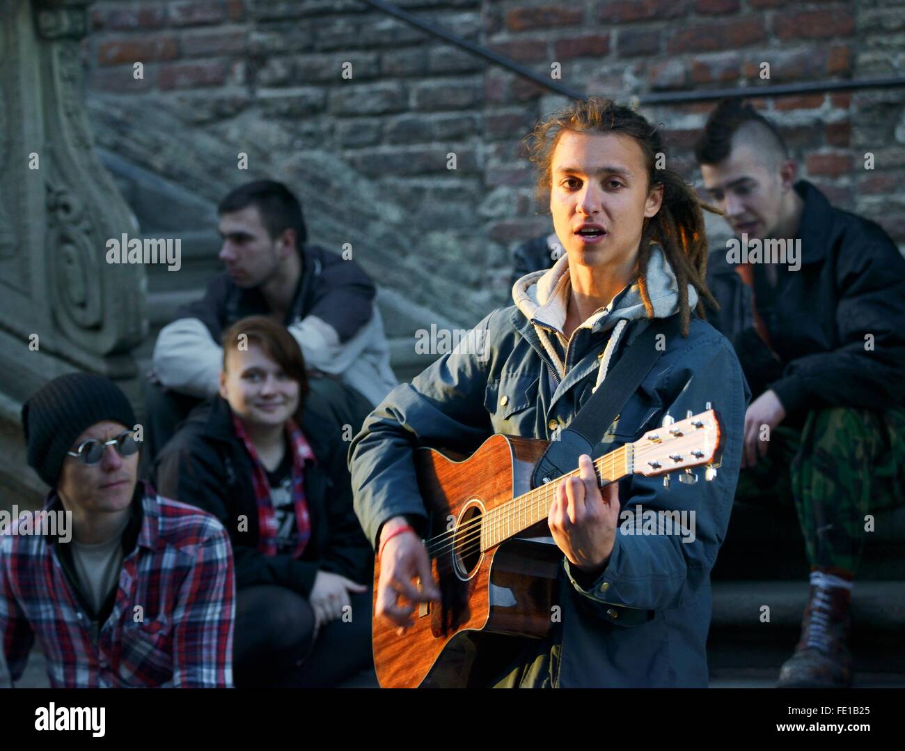 Gdansk Poland. Young street musician singing busking outside the Main Town Hall on the Dlugi Targ Long Market Stock Photo