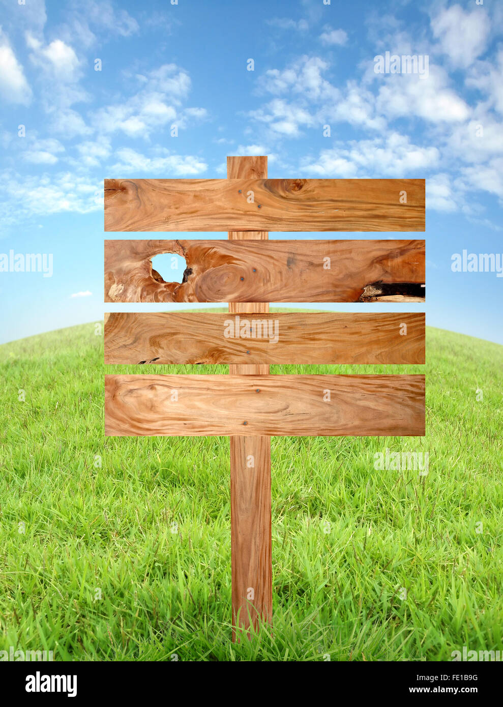 wooden signboard  with meadow and blue sky Stock Photo
