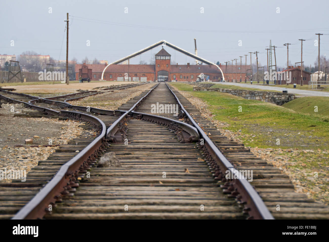Railway leading to the entrance of the Nazi death camp at Auschwitz in Poland. Stock Photo