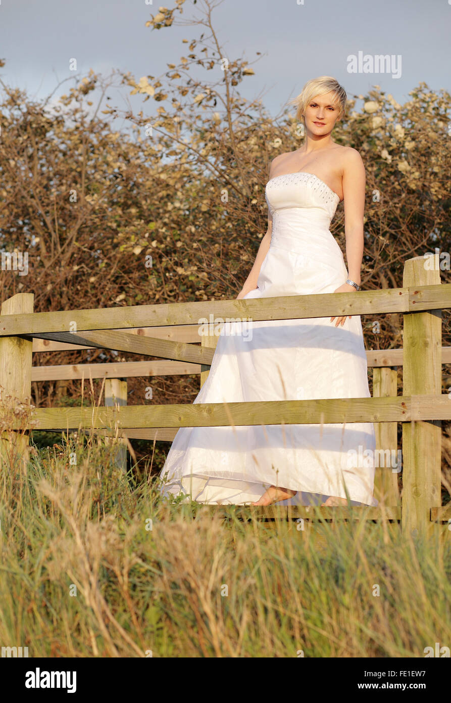 Beautiful young bride on a fashion shoot during the golden hour of Dusk. Stock Photo