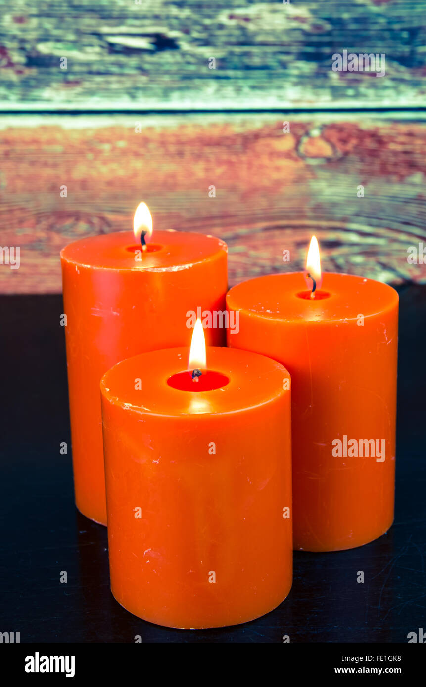 burning orange candles still life Stock Photo Alamy