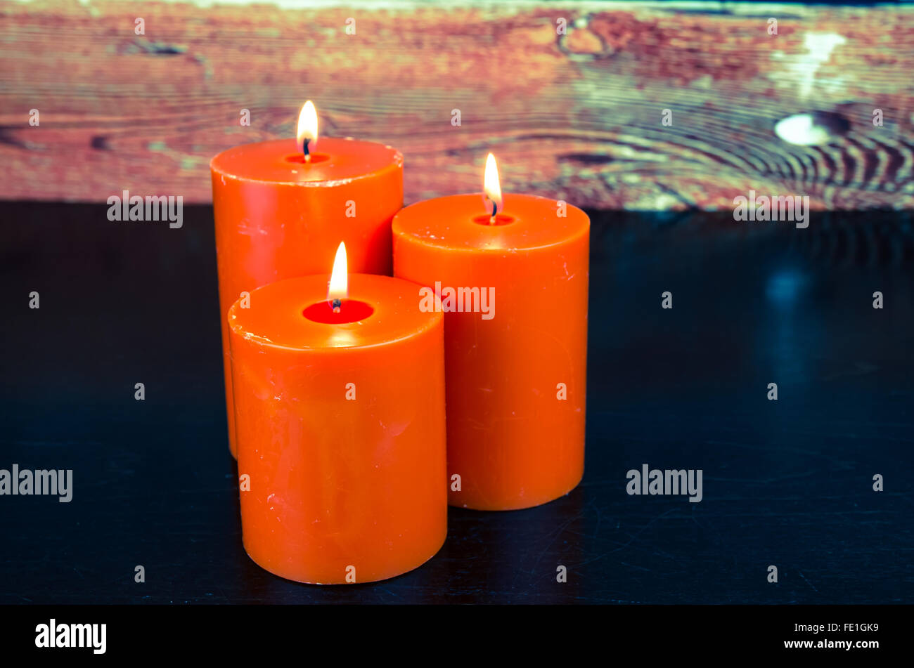 burning orange candles still life Stock Photo Alamy