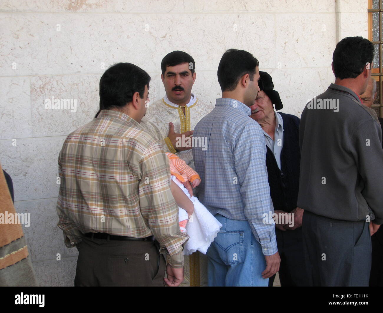 The Priest greeting the community before the Sunday Mass at the Aghia Sophia Church, Saidnaya, Syria Stock Photo