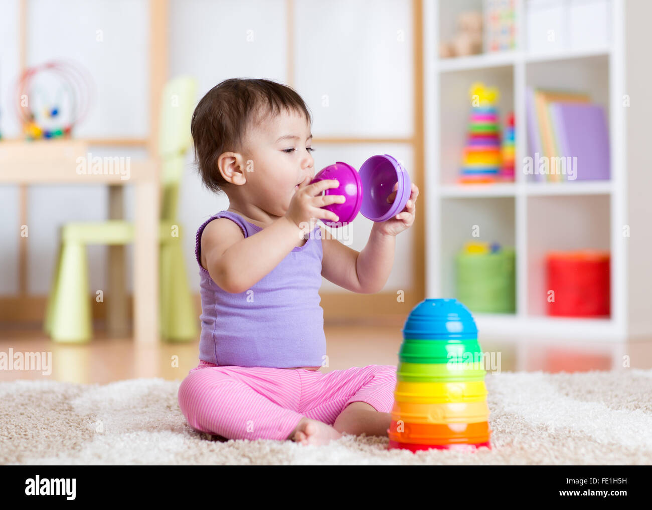 Child girl playing with toy at home Stock Photo - Alamy