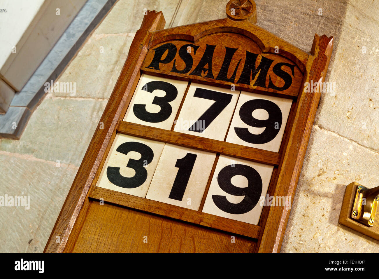 Traditional church interior in England UK with psalm numbers on a wooden board for use in an Anglican service Stock Photo