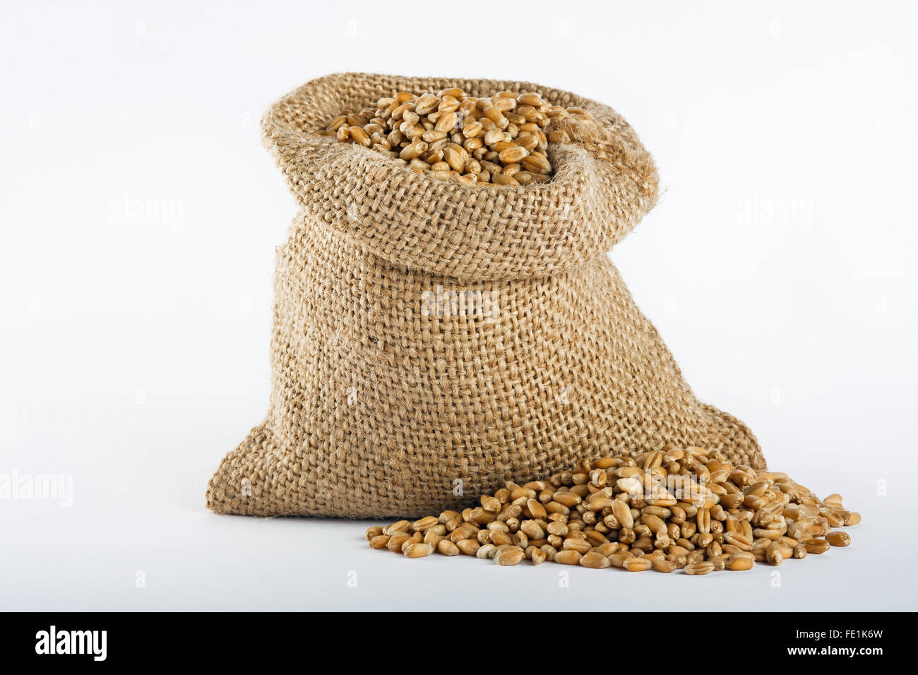 Wheat grain in small burlap sack Stock Photo
