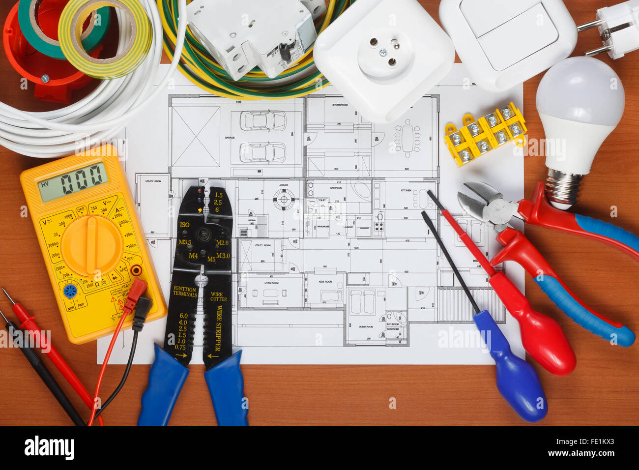 Electrical equipment, tools and house plans on the desk Stock Photo