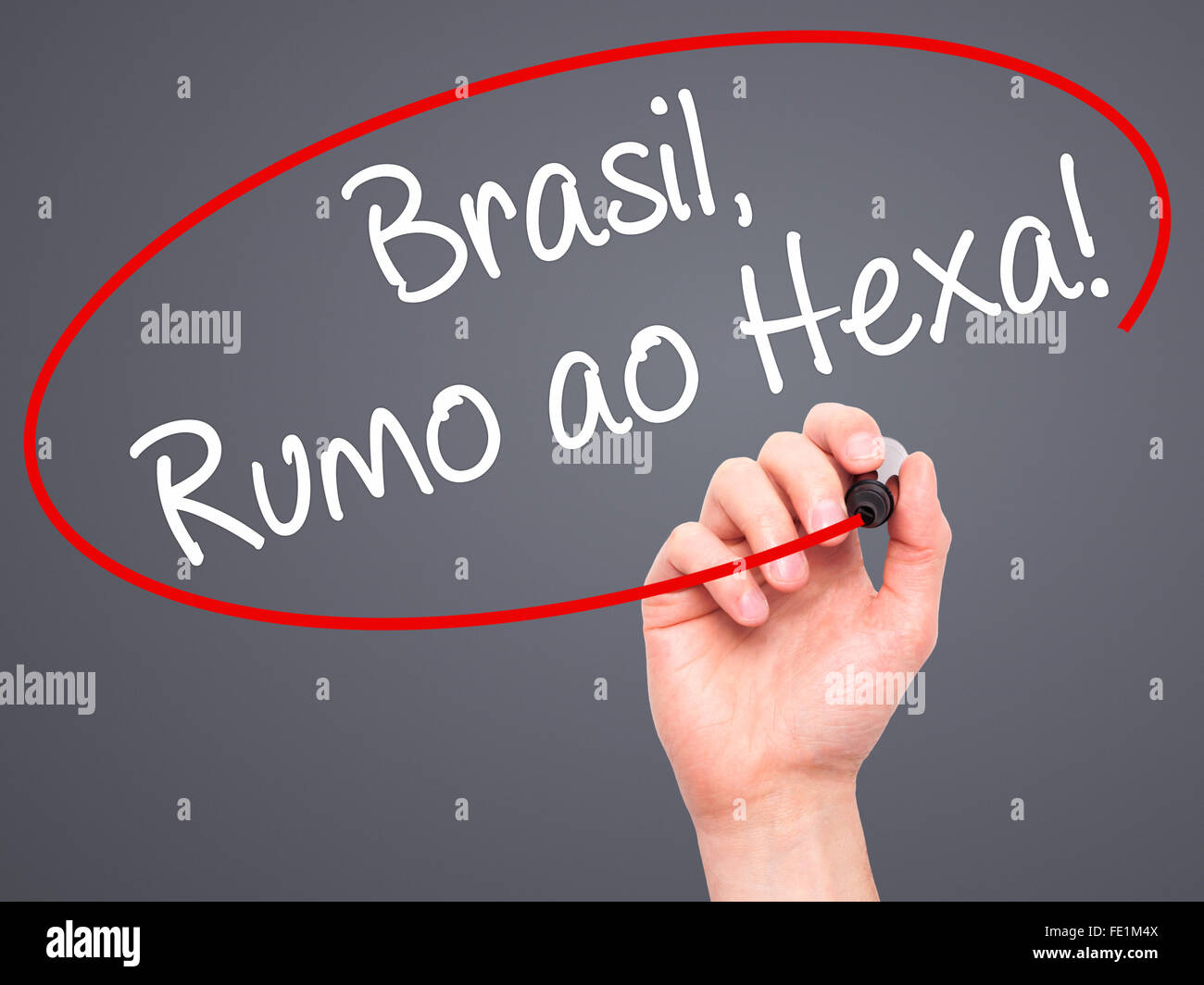 Man Hand writing Brasil, Rumo ao Hexa! with black marker on visual screen. Isolated on background. Business, technology, interne Stock Photo