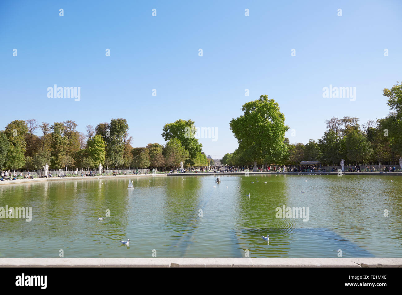 Tuileries garden with people, pond view in Paris Stock Photo