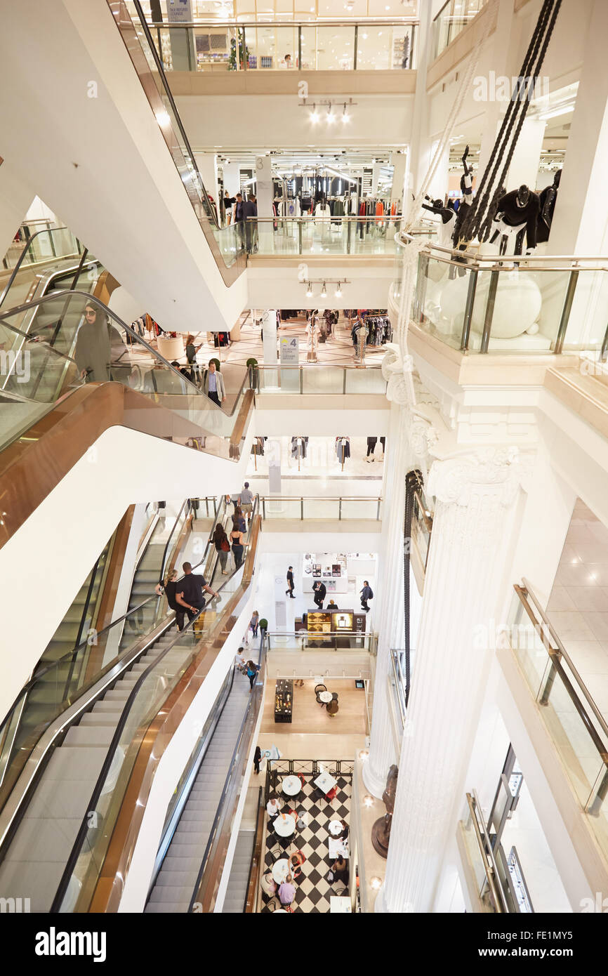 Selfridges department store interior, escalators with customers and visitors in London Stock Photo