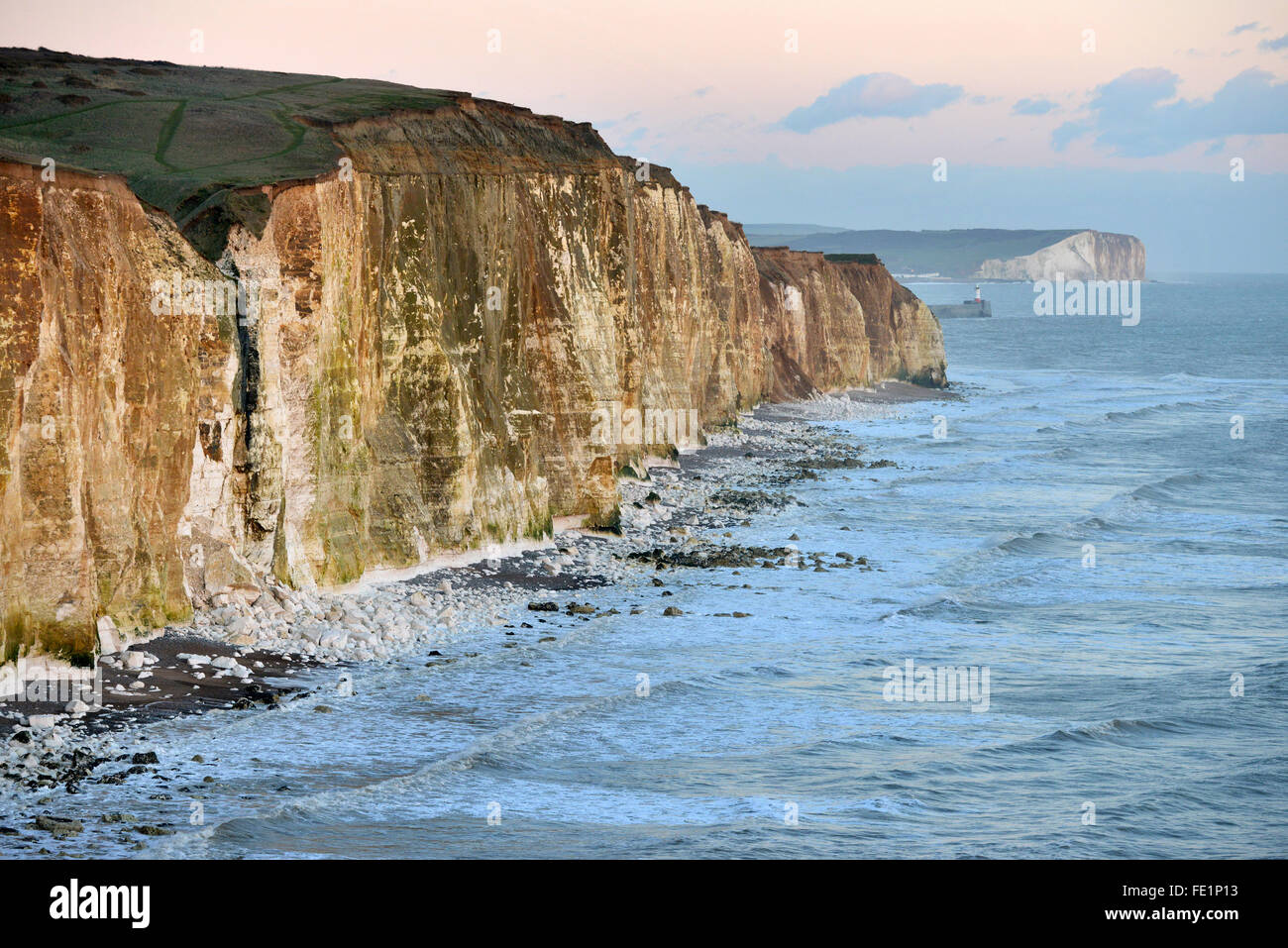 Chalk cliffs and lighthouse at sunset - Newhaven and Seaford, East Sussex, UK Stock Photo