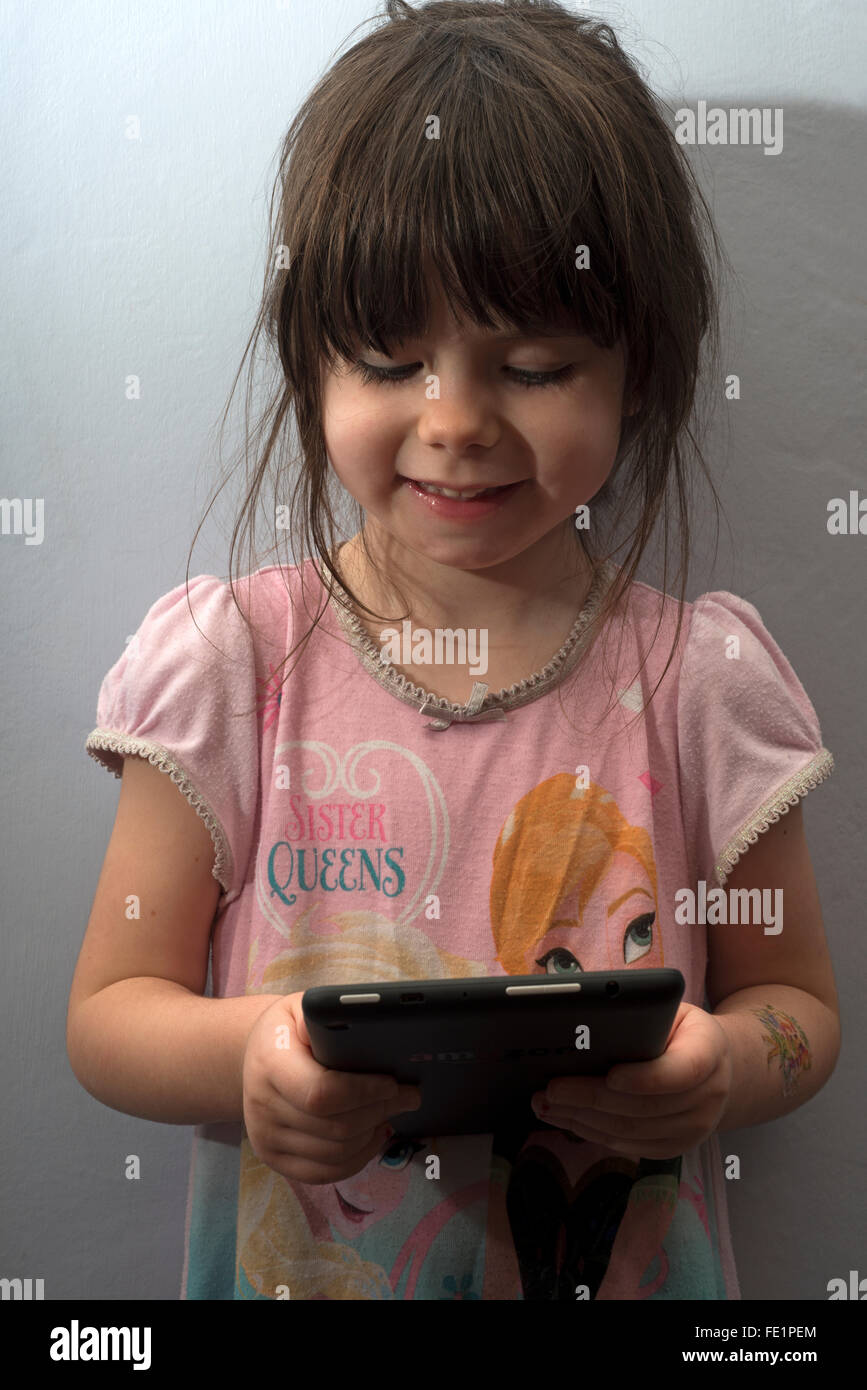 3-year old child using an Amazon tablet Stock Photo