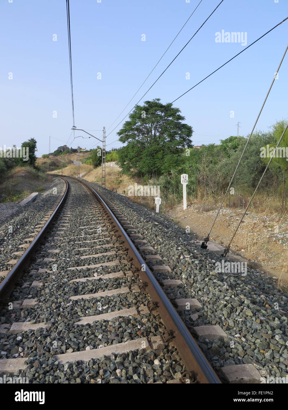 Curved Railway track in ballast on local line between Alora and Malaga, Andalucia Stock Photo