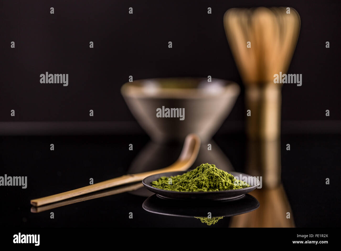 Macha green powder in a plate on black clipping path surface Stock Photo