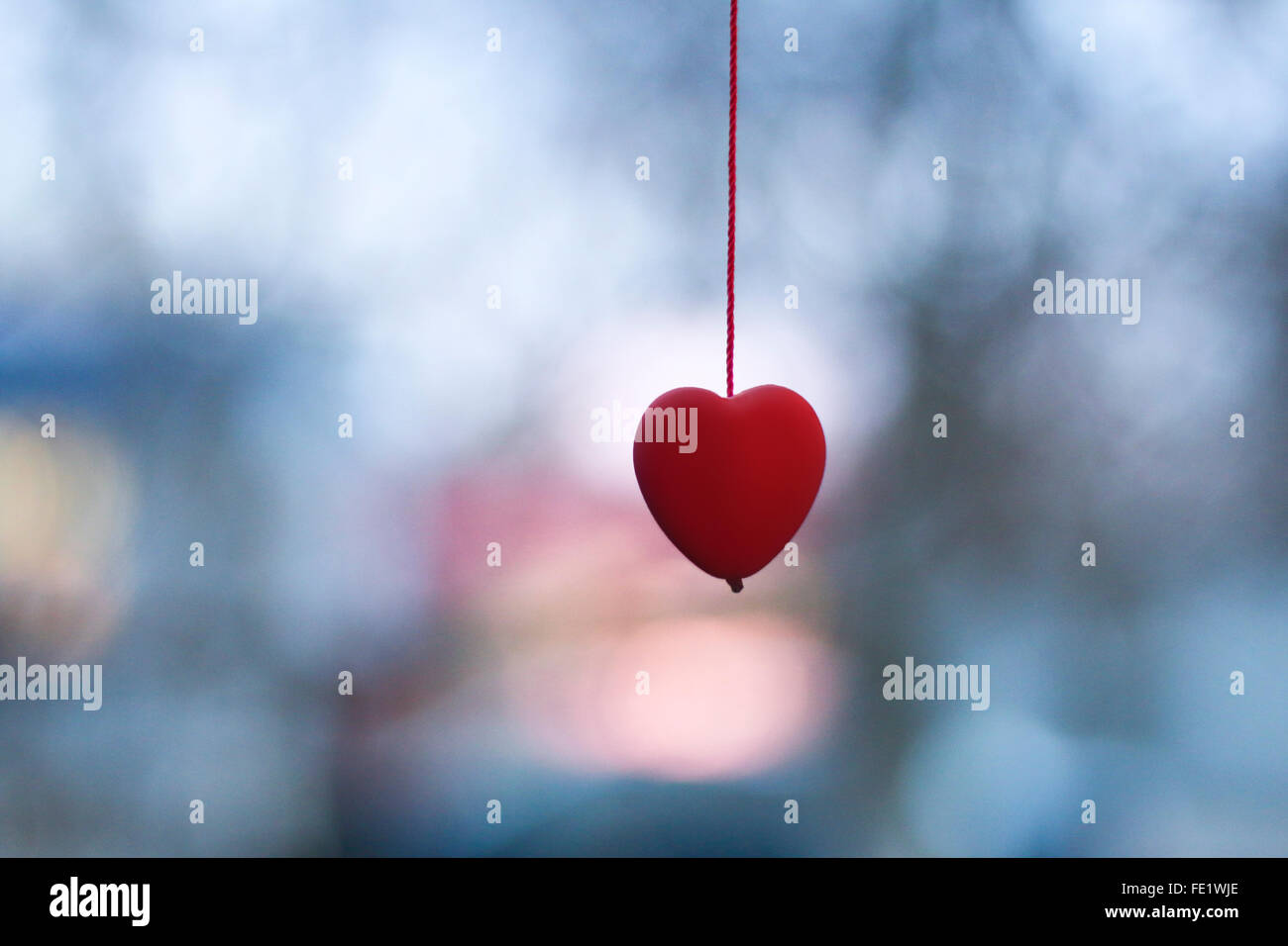 valentine holiday greeting card with red heart on blurred background Stock Photo