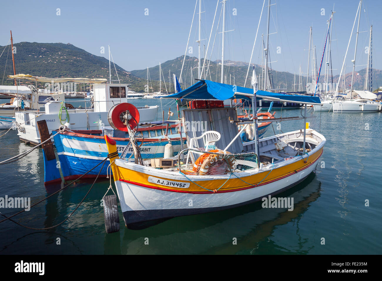 Propriano, France - July 3, 2015: Small colorful wooden fishing boats moored in Propriano resort town, Corsica, France Stock Photo