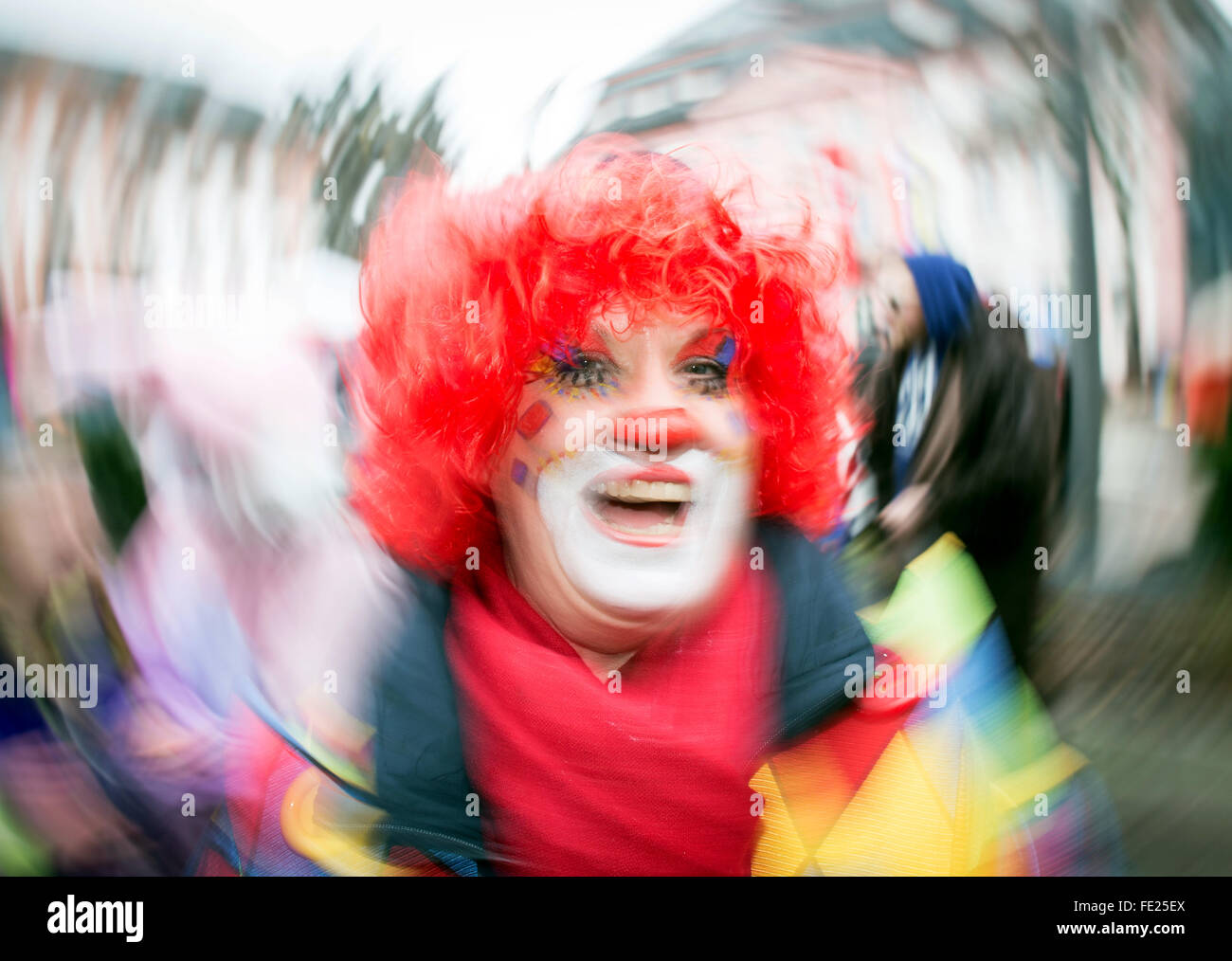 Mainz, Germany. 4th Feb, 2016. A feamle Carnival enthuasiast diguised as a clown cheers on the central 'Fastnachtsbrunnen' square during the street Carnival festivities in Mainz, Germany, 4 February 2016. The Women's Carnival marks the beginning of the street carnival season in Mainz. Photo: Frank Rumpenhorst/dpa/Alamy Live News Stock Photo