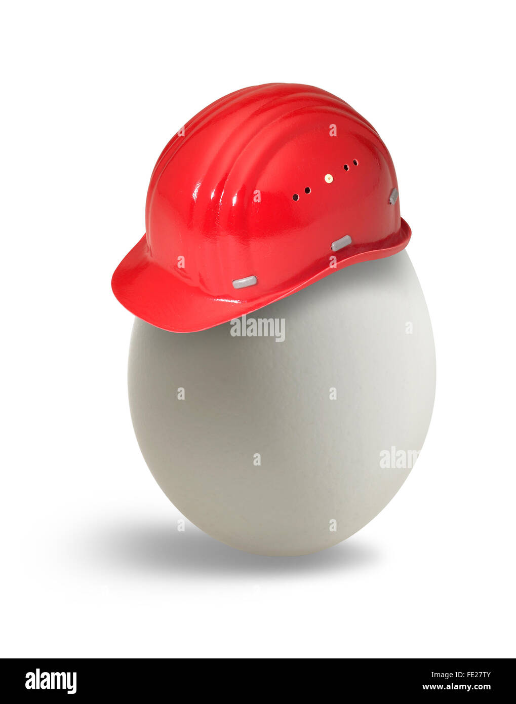 egg with red hardhat in light back Stock Photo