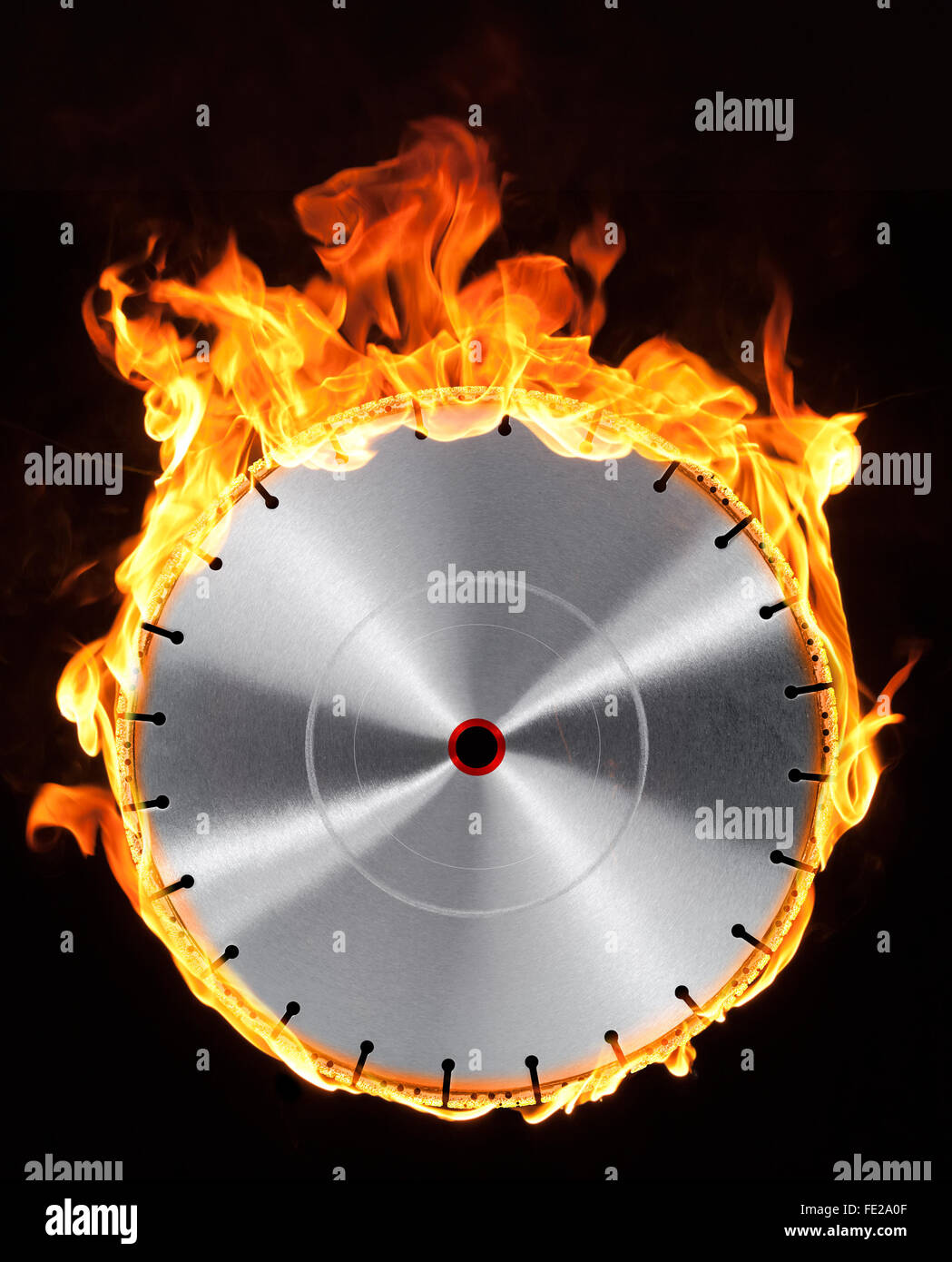 frontal shot of a diamond studded burning cutting wheel in black back Stock Photo