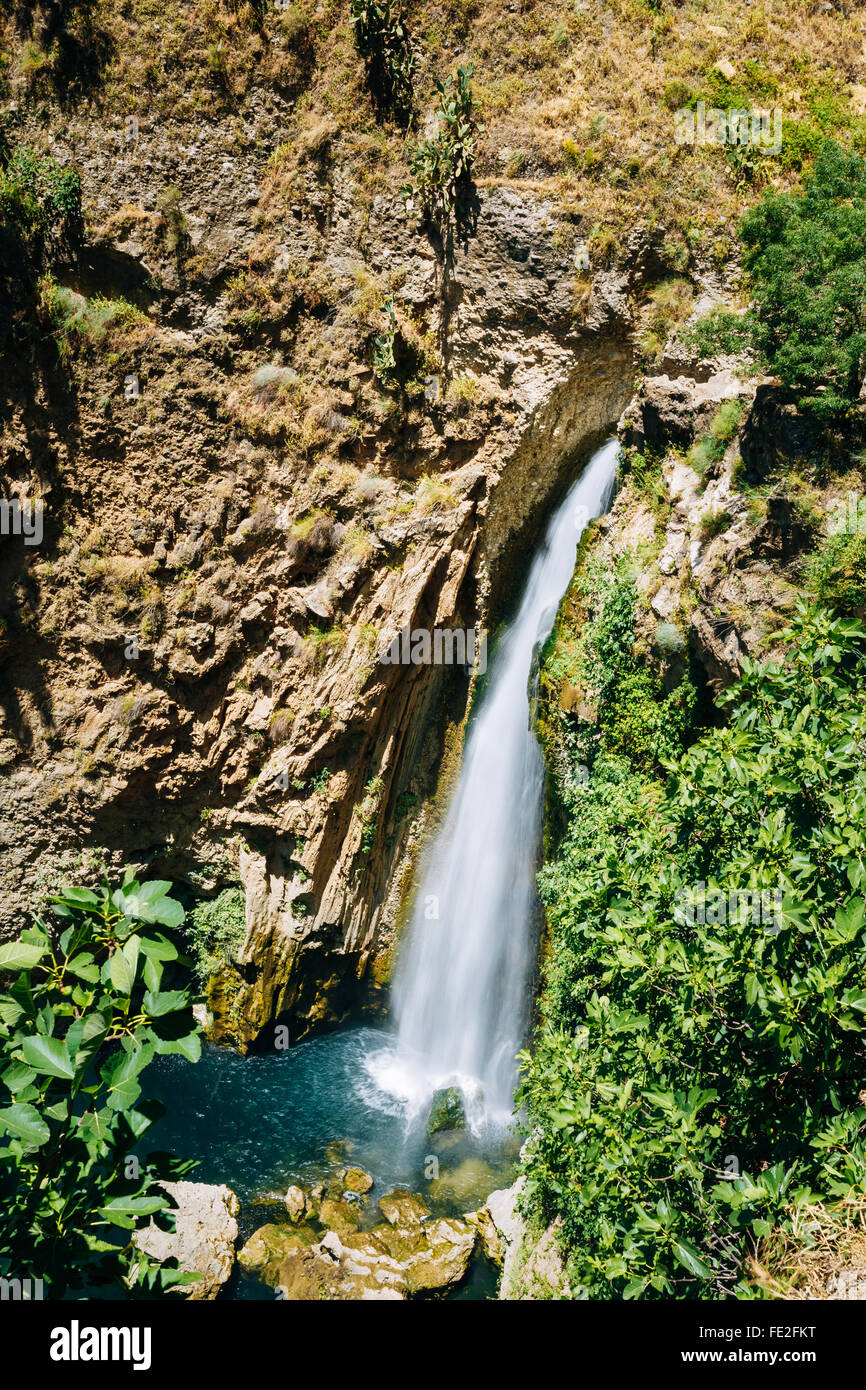 Waterfall under the New Bridge (Puente Nuevo) in the city of Ronda, Malaga Province, Spain. Stock Photo