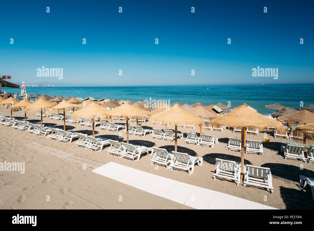 Beach sun loungers by the Mediterranean Sea. Chaise longues on the beach. Sunbed and umbrella on beach Stock Photo Alamy