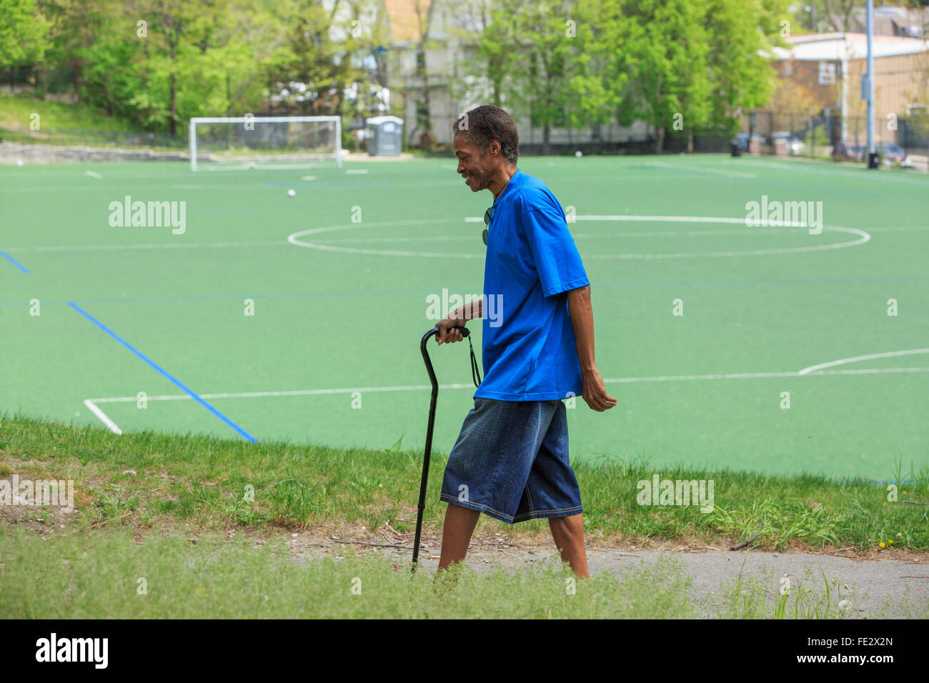 Man with Traumatic Brain Injury taking a walk with his cane near a
