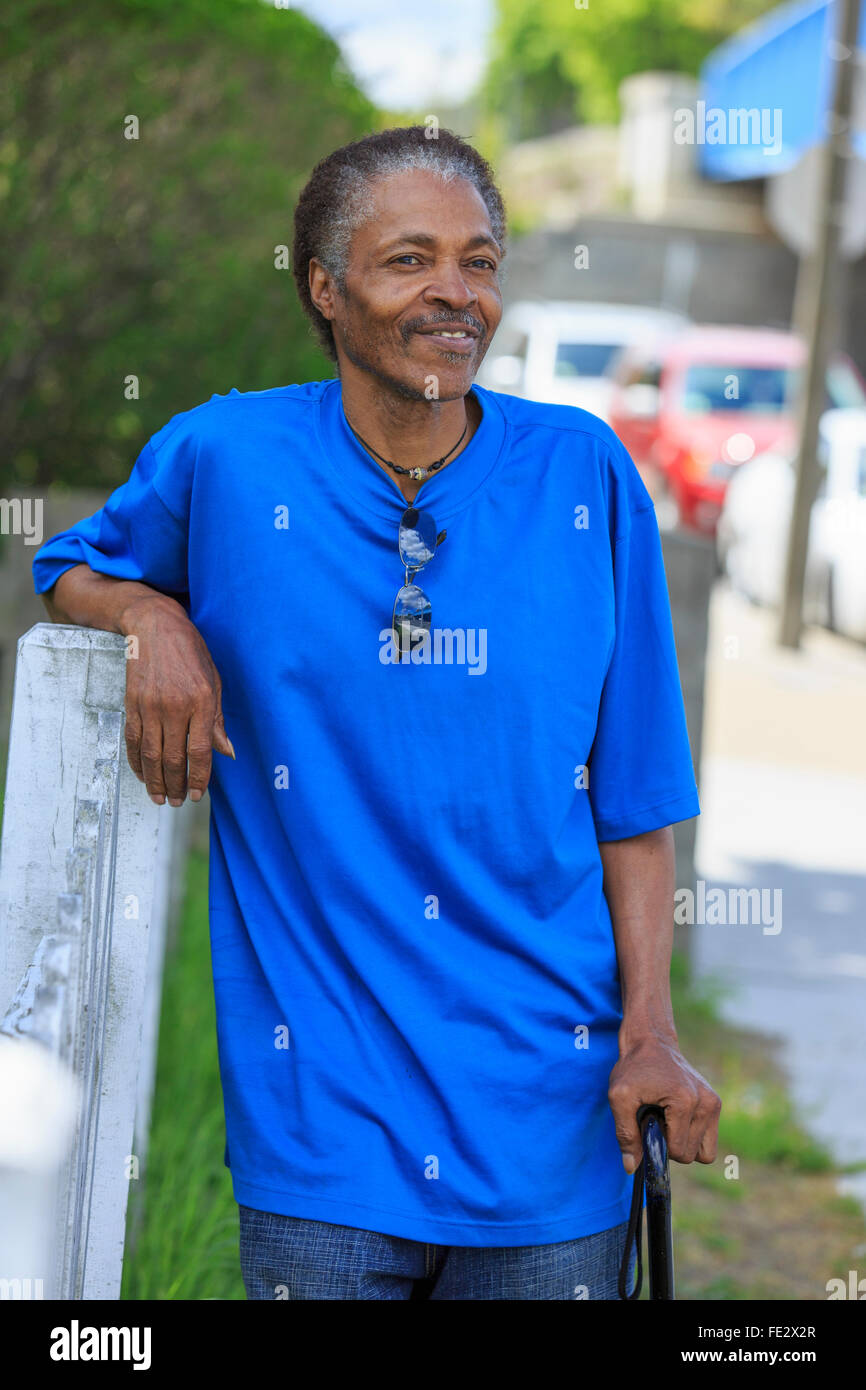 Man with Traumatic Brain Injury relaxing with his cane in his