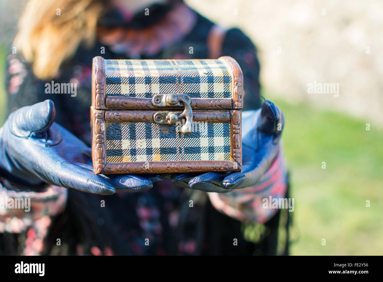 Young woman holding an old  wooden box outdoors Stock Photo