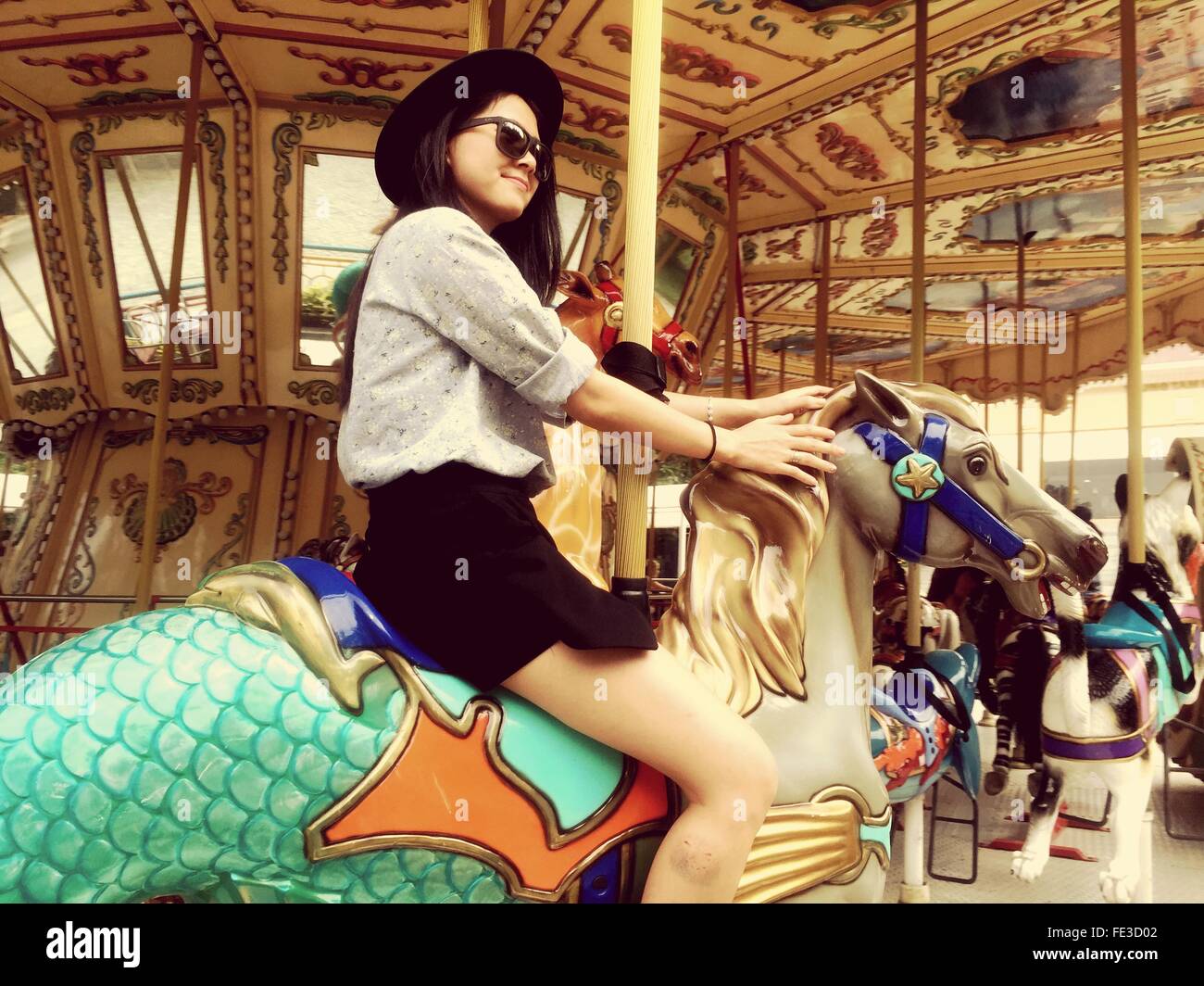 Woman sitting horse on carousel hires stock photography and images Alamy