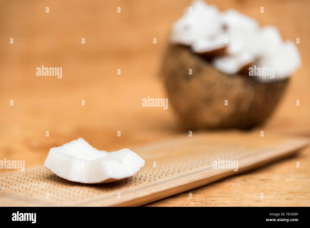 Old coconut cut on wooden background in two parts with negative space Stock Photo