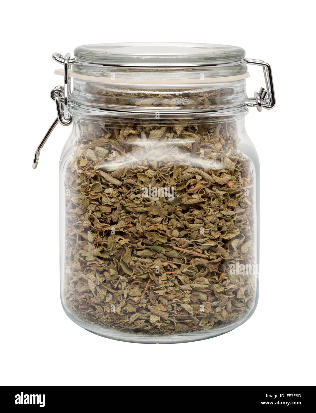 Dried Oregano Leaves in a Glass Canister with a Metal Clamp. The image is a cut out, isolated on a white background. Stock Photo