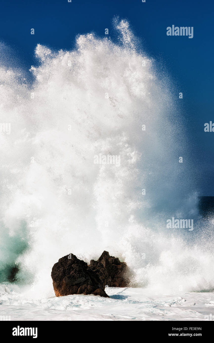 Massive waves explode against the offshore lava rocks at Laupahoehoe